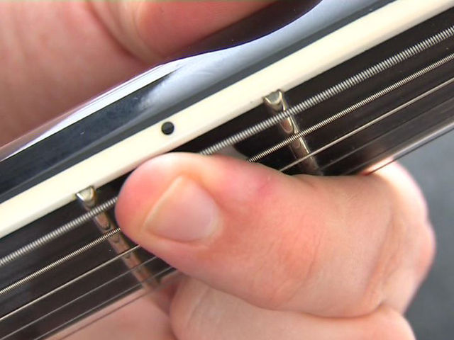 Pressing down near the frets eliminates the possibility of fret-buzz